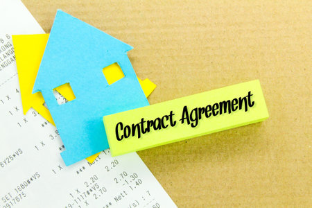 receipts, paper houses and colored paper with the words contract agreement