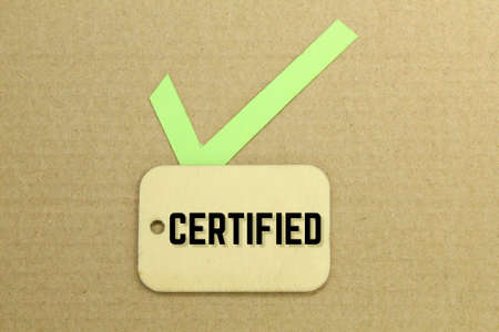 correct marks and wooden tags with the word certified. checklist conceptの写真素材