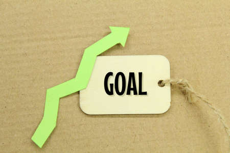 green ascending arrow and a wooden tag with the word goalの写真素材