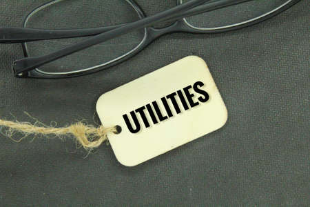 glasses and wooden tags with the word utilityの写真素材