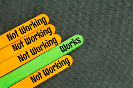 colored ice cream sticks with the words work and not workingの写真素材