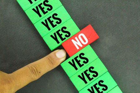 colored wooden boards with the words No and Yes. the concept of right and wrong segregation