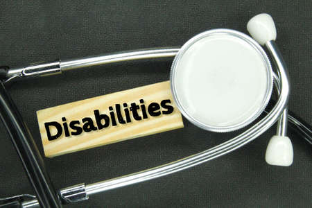 stethoscope and wooden board with the word disabilities