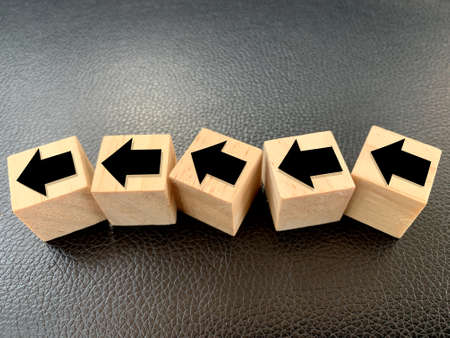 wooden cubes with the direction of following the winding arrow. concept towards successの写真素材