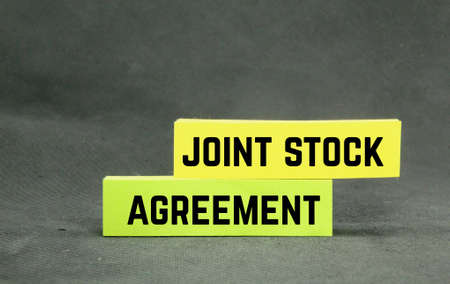 colored paper with the words joint stock agreementの写真素材