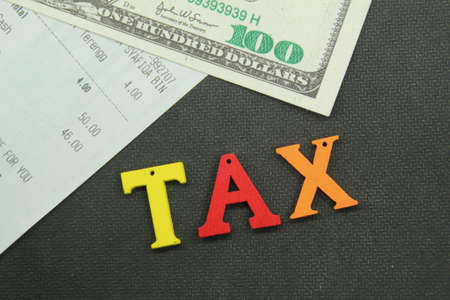banknotes and receipts with the word tax. tax conceptの写真素材
