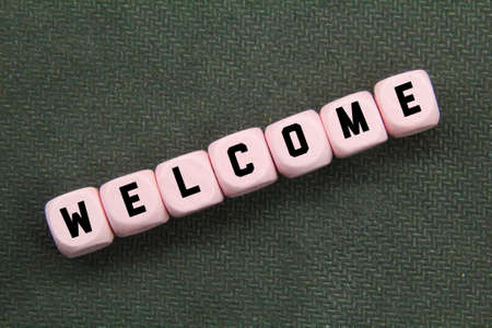 a pink cube with the word welcome. the concept of welcoming attendance