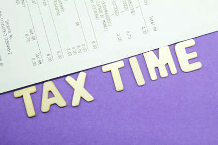 receipts and wooden letters with the words Tax Time