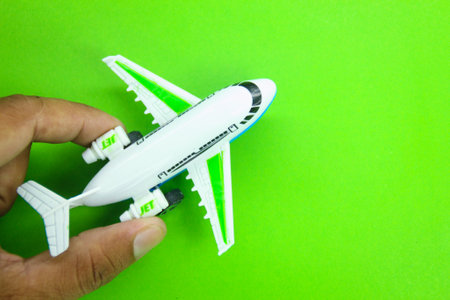 hands holding an airplane or jet to head to a destination or journeyの写真素材