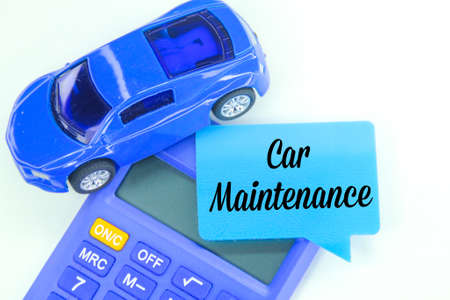 toy cars, calculators and conversation boxes with the word car maintenance. car maintenance concept