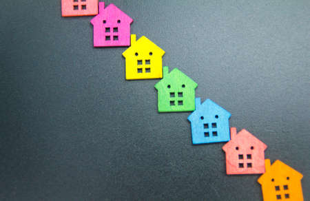 a small colored wooden house with a real estate or mortgage concept with a copy space on the sideの写真素材
