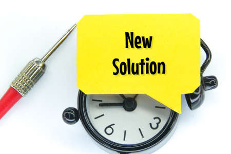 alarm clock, arrow and conversation box with the word new solutionの写真素材