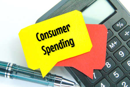 calculators, pens and conversation boxes with the word consumer spending