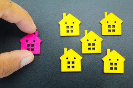 fingers choose the house of choice. the concept of choosing a dream home