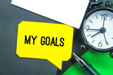 alarm clock, pen and conversation box with the words my goalsの写真素材