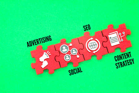puzzles with advertising, social, SEO and content strategy icons. Marketing plan concept
