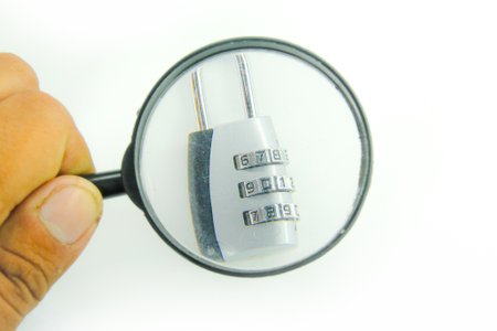 hand holding a magnifying glass searching for a code or passwordの写真素材
