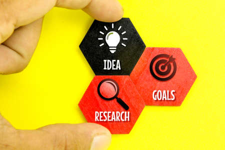 colored wooden hexagons with research idea goal icons. concept towards successの写真素材