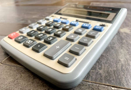 calculator with a wooden background. the concept of calculation or accountantの写真素材