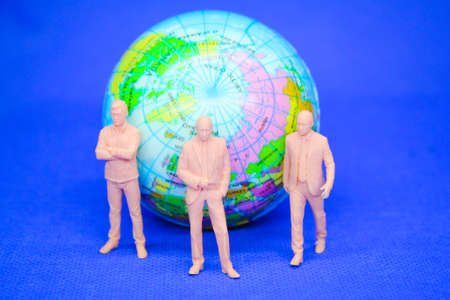 Joint venture. Cooperation. Global Business. Businessman with blurred earth background.
