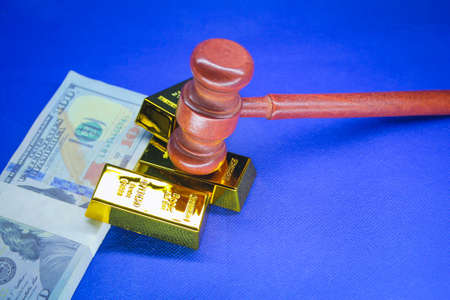 judge's gavel, paper money and gold bar with the concept of financial judgmentの写真素材