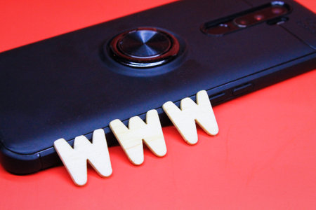 www wooden letters with smartphone background. website conceptの写真素材