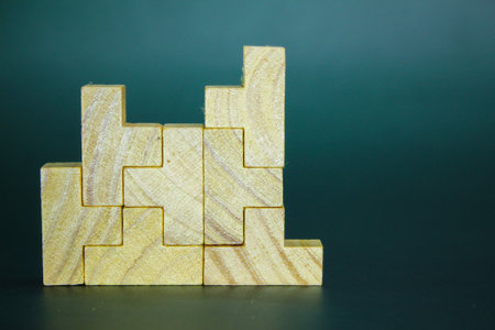 arrangement of wooden puzzles upwards. Concept of building success foundation.
