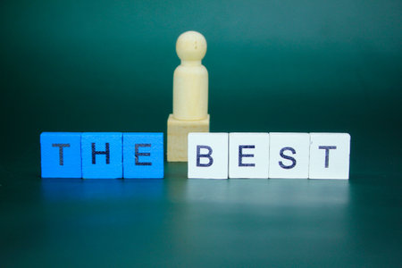 blue and white square with the word the best with a blurred wooden figure background. best concept.の写真素材