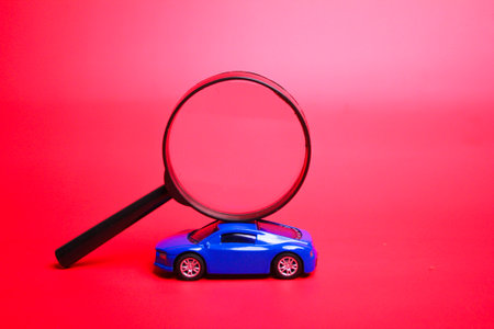 magnifying glass and car. the concept of finding a vehicle or carの写真素材