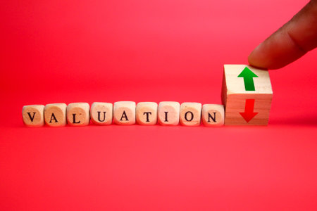 wooden cube with the word valuation and up and down arrows. Valuation up or down Conceptの写真素材