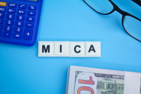 money, calculator, glasses with the word MiCA or Markets in Crypto Assets.の写真素材