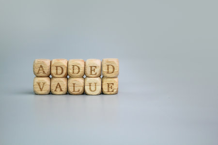 wooden cube with the word Added Value. Business, customer value conceptの写真素材