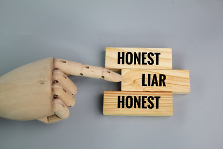 wooden board with the words honest and liar. reject the word liar
