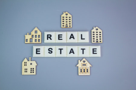 shape of a small wooden house with the word real estate. real estate concept. housing real estate...