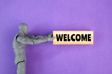 human miniature with the word welcome. the concept of welcoming a customer or person