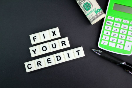 paper money And calculator with the words fix your credit. Credit repair is the act of restoring or correcting a poor credit score.の写真素材