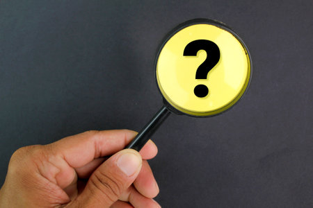 magnifying glass and question mark. the concept of finding a solution. the concept of questioning and finding answersの写真素材