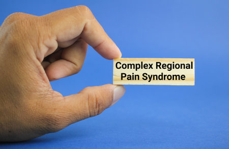 hand holding a stick with the words Complex regional pain syndrome or CRPS