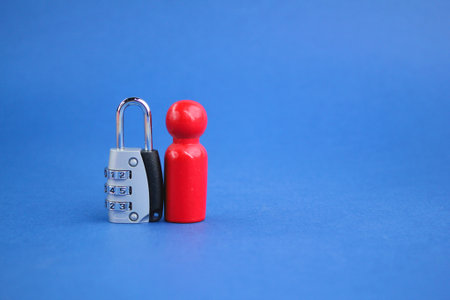 Wooden figure and key. the concept of men and privacy. the concept of identity is protected. the concept of one's privacyの写真素材