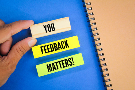 books and colored paper with the words your feedback matters. customer feedback concept.の素材 [FY310197628209]