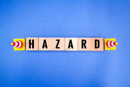 cones and wooden cubes with the word hazard. danger concept or danger signの写真素材