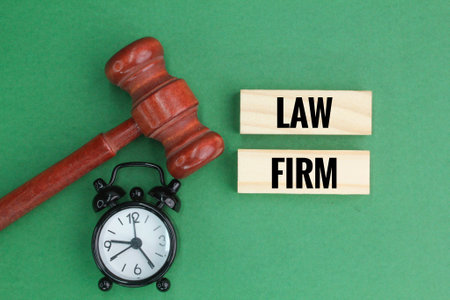 bell clock and judge's gavel with the word law firmの写真素材