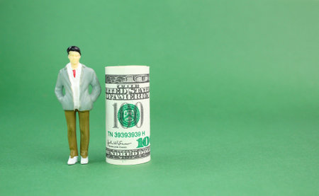 a roll of paper money with a miniature people. Money from Trading, Business Success Concept. profit concept. Investment business conceptの写真素材