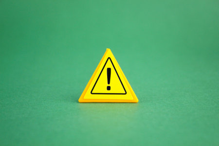 exclamation mark in yellow triangle. the concept of danger or cautionの写真素材