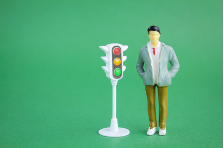 miniature people with traffic lights on the side. traffic light compliance conceptの写真素材