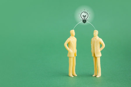 two miniature people discussing an idea. business discussion concept. business management conceptの写真素材
