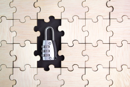 wooden puzzle with a key in the middle. cyber security concept. safety and security concept.の写真素材