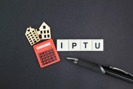 calculator, house form and pen with the letters IPTU or the word Imposto sobre a proprieta predial e...