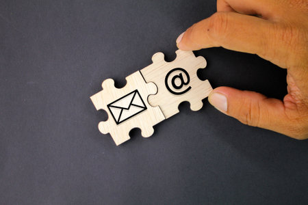 wooden puzzle with email icon and email address. Concept email address. Internet technologies and contacts for communicationの写真素材
