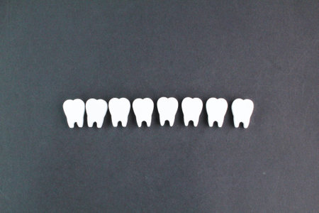 A row of white teeth on a black background. health concept and dental examinationの写真素材